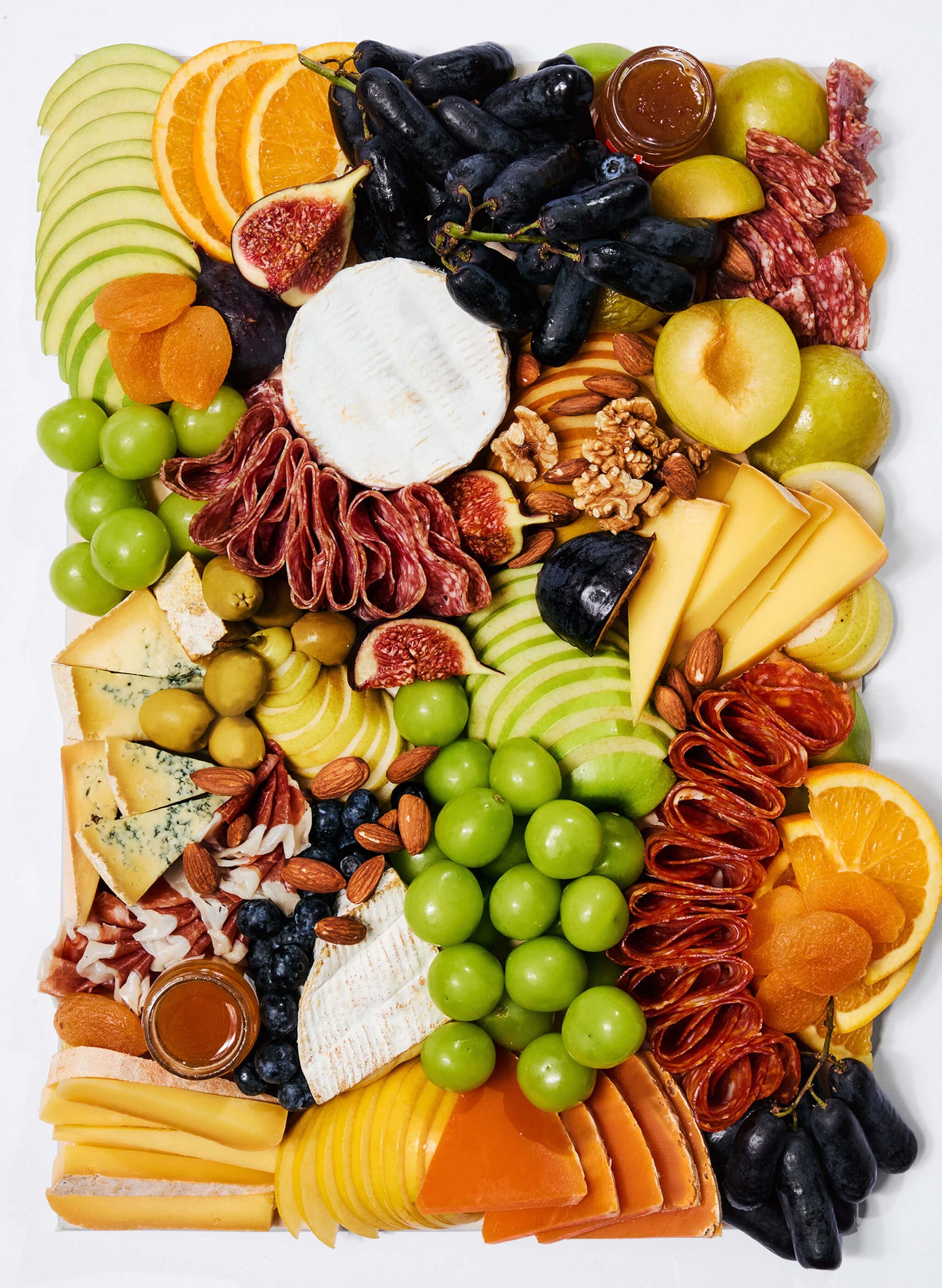 A cheese platter of nicely cut finest cheese and cold cuts with antipasti, nuts, fresh & dried fruits, vegetables, mini honey & chutney pots, topped with seasonal garnishes. Comes ready to eat. The perfect pick for home parties, corporate event or as a gift. Free delivery Hong Kong.