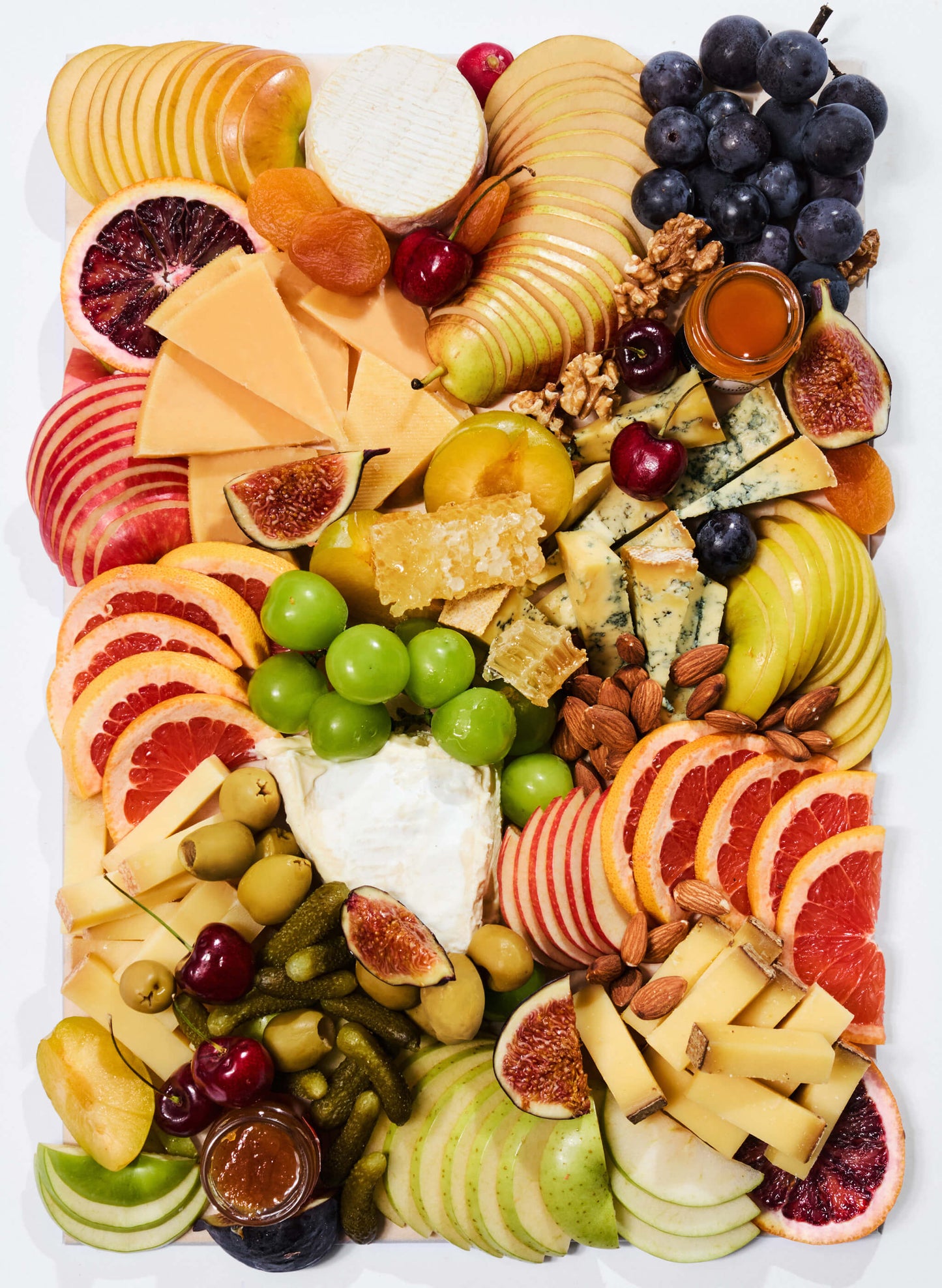 A cheese platter of nicely cut finest cheese and cold cuts with antipasti, nuts, fresh & dried fruits, vegetables, mini honey & chutney pots, topped with seasonal garnishes. Comes ready to eat. The perfect pick for home parties, corporate event or as a gift.