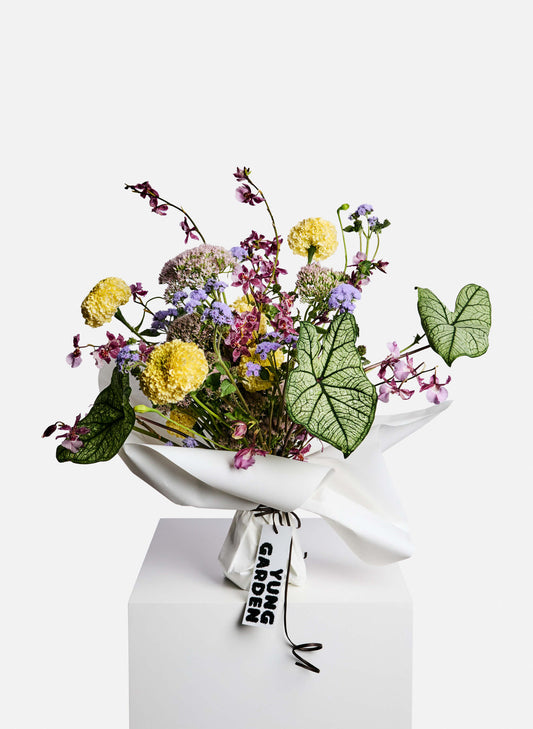 A vibrant seasonal flowers bouquet featuring allium, marigold, orchid and green. Free delivery Hong Kong.